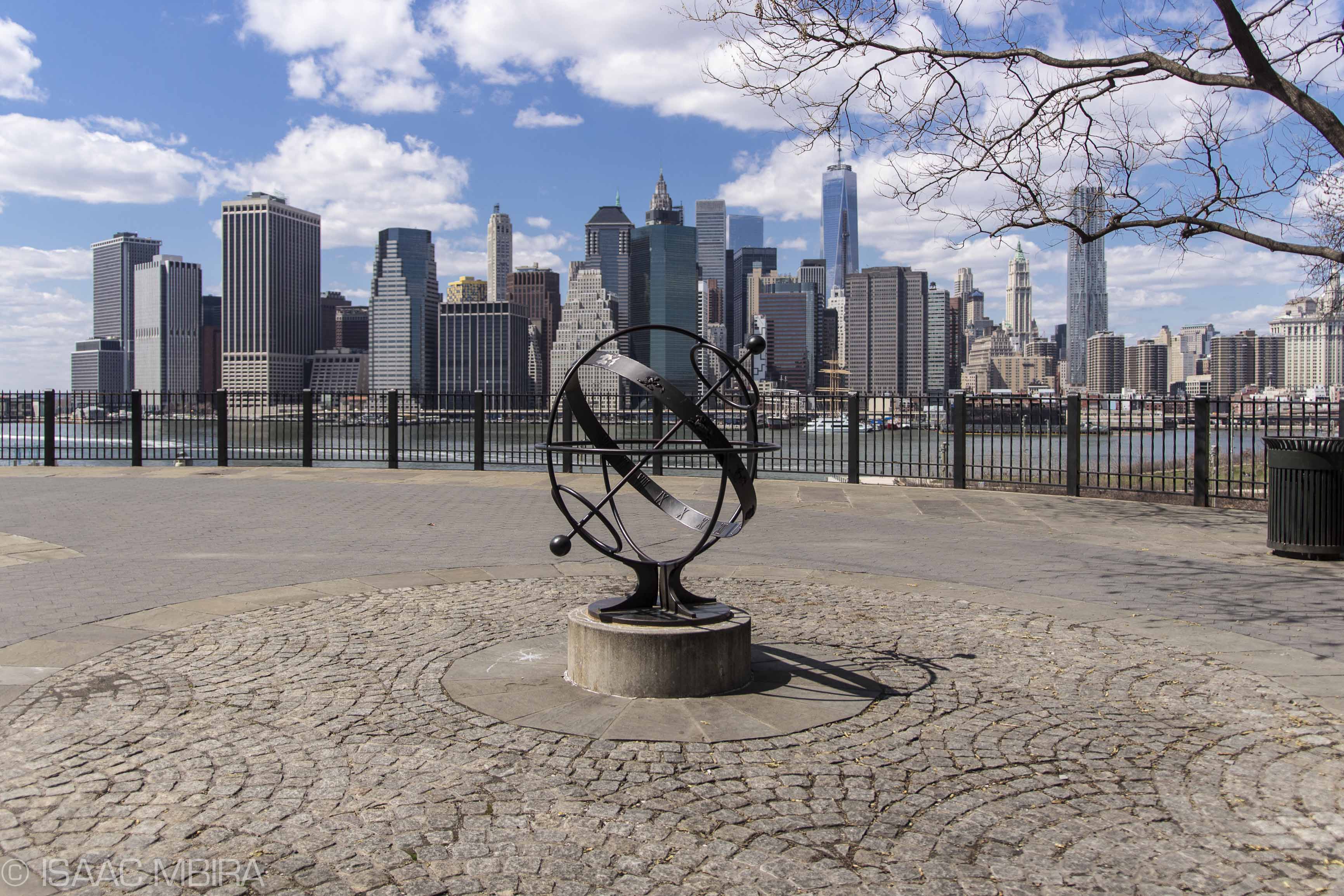 Image of Downtown Manhattan as seen from the Brooklyn Heights Promenade, with sundial in foreground